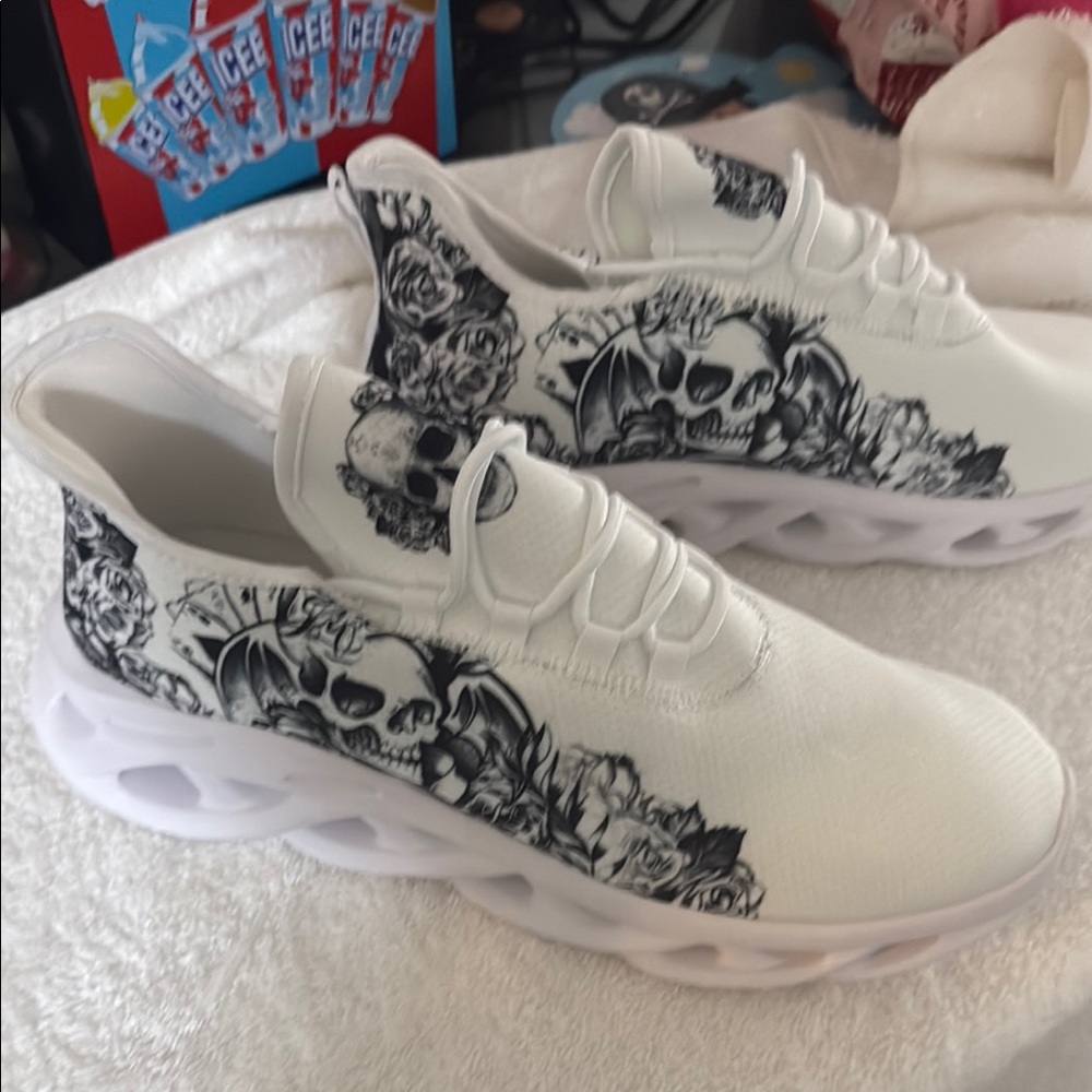 White Sneakers with Black Skull Design